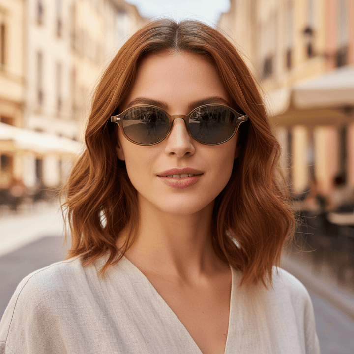 Front view a women wearing sunglasses polarized ovaladas color oliva with color lenses gradient oliva modelo capri bonoboss. eyeglasses oval retro moda for men and women #color_olive-light