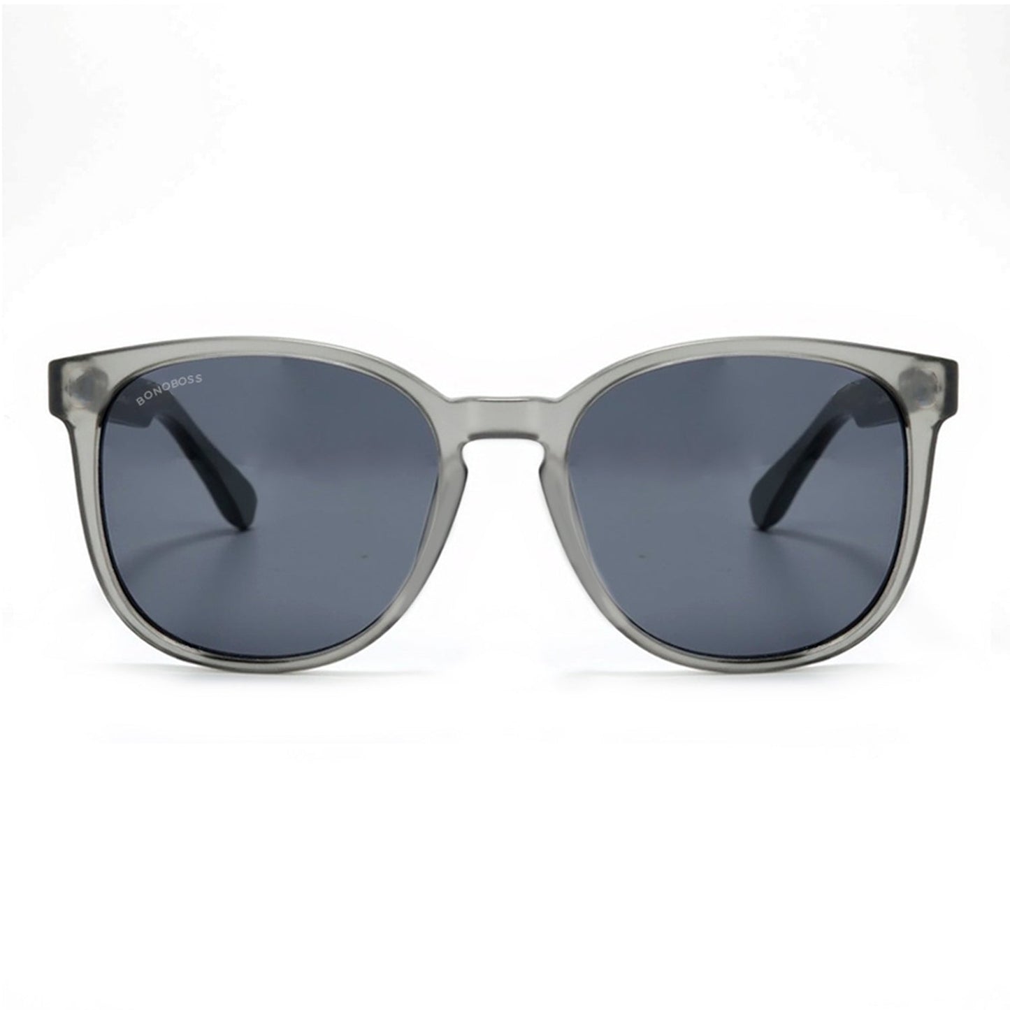 anteojos redondos de plástico reciclado y varillas de madera natural sustentable con lentes de color rosado. Polarizadas y forma redonda. La gafa es color transparente #color_negro