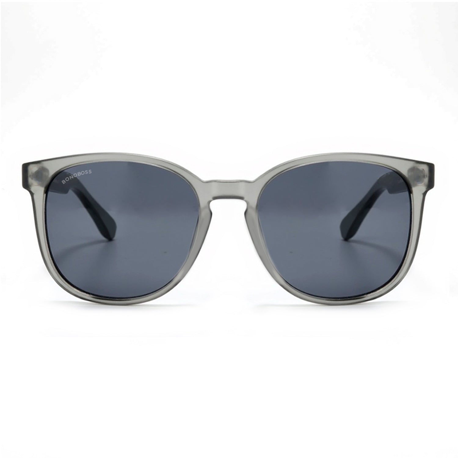 anteojos redondos de plástico reciclado y varillas de madera natural sustentable con lentes de color rosado. Polarizadas y forma redonda. La gafa es color transparente #color_negro