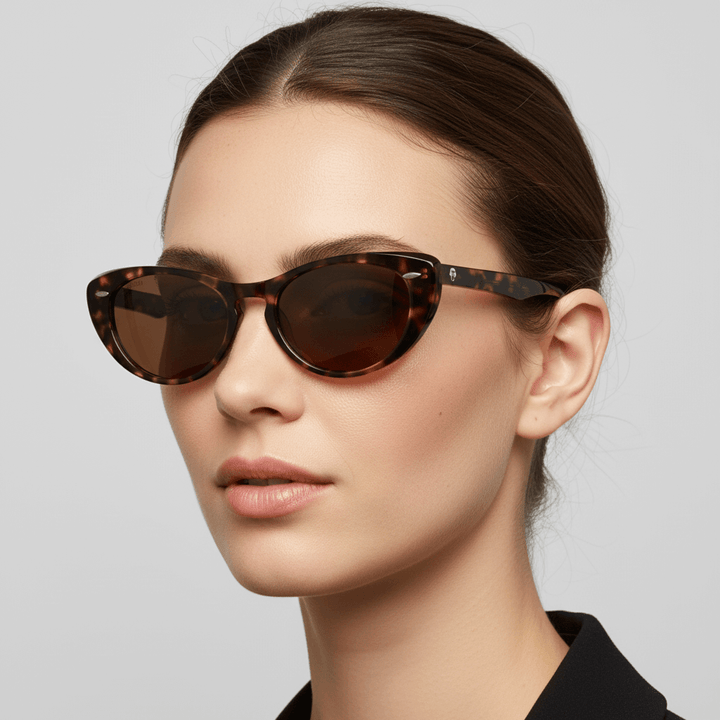 La side view a women pelo tomado castaño oscuro with round faces wearing unos sunglasses polarized bonoboss tortoise with lenses brown with puntos metalicos in the costados forma agatada and with a puente for a nariz ancha #color_carey