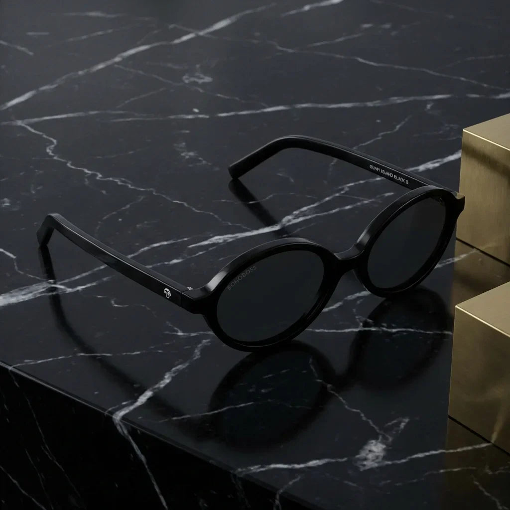 Lentes sol Guapi Island polarizados UV400 bio-acetato negro sobre marmol negro superficie premium elegante Bonoboss #editorial_polarizado #color_negro