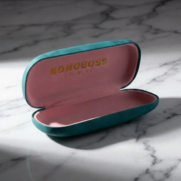 Estuche almeja for lenses calipso abierto sobre mármol bonoboss #color_calipso