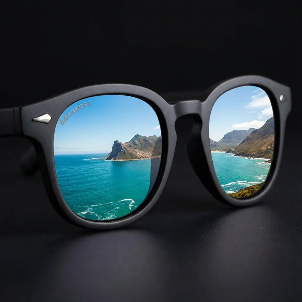 Lentes sol Waimea polarizados UV400 marco RPET reciclado del oceano negro close-up lente reflejo paisaje costero Bonoboss #editorial_polarizado #color_negro